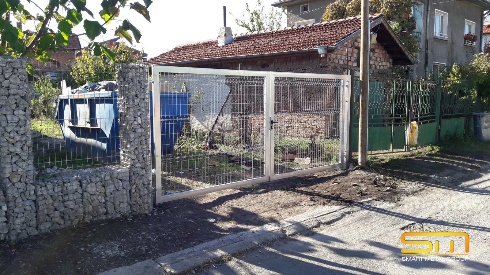 Double driveway gate beside the combined gabion fence in Kostinbrod